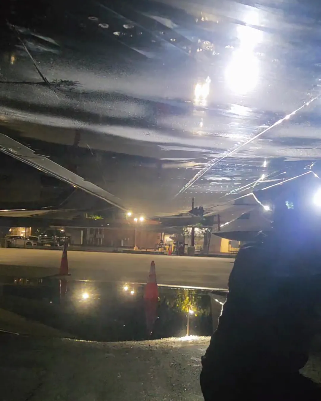 Overnight aircraft detailing under a headlamp on a California airport ramp