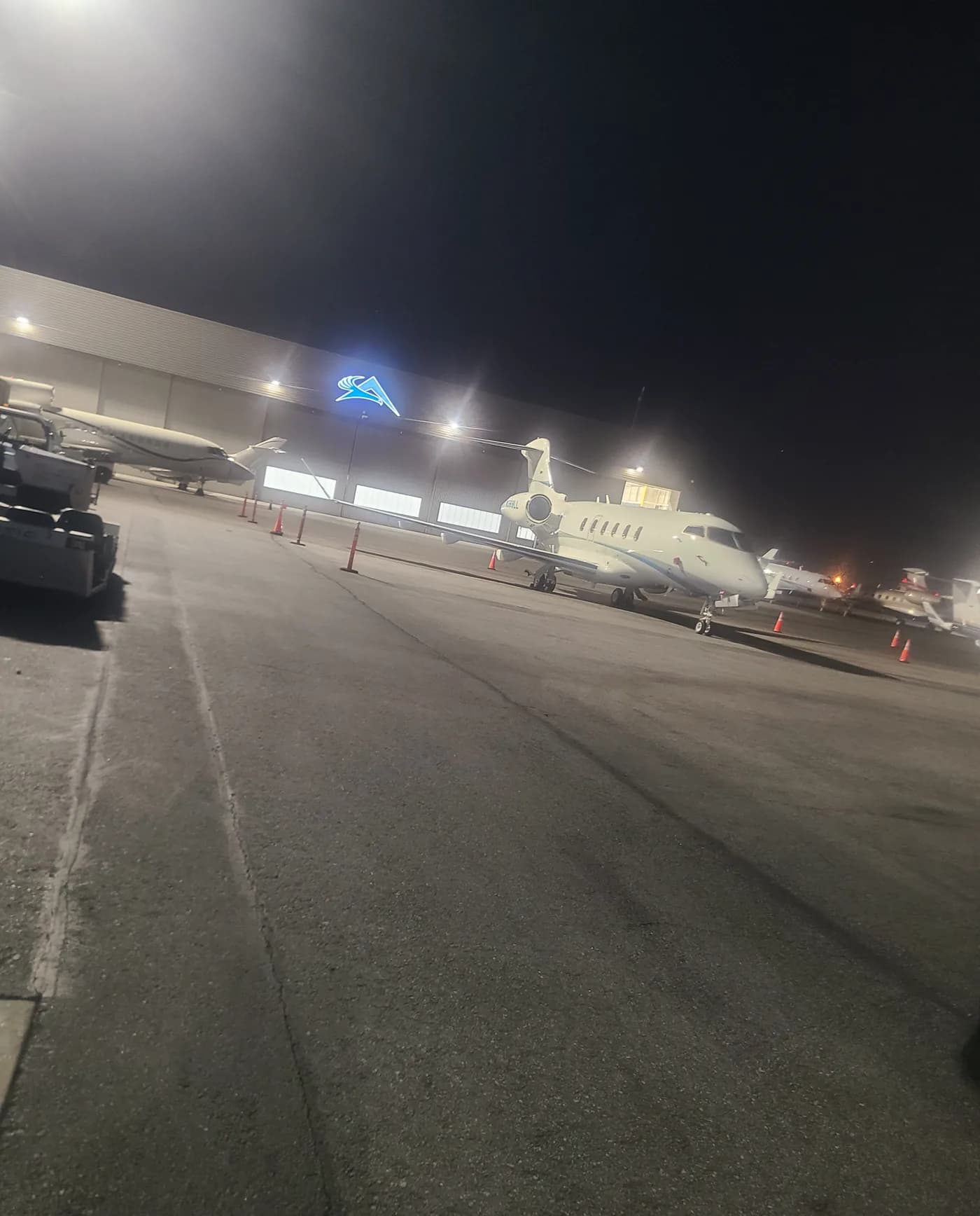 Private jet parked in a hangar at night before detailing
